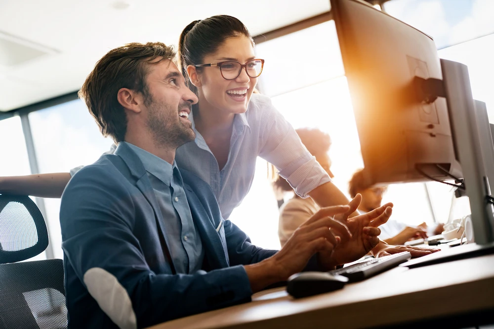 IT professionals working together at computer